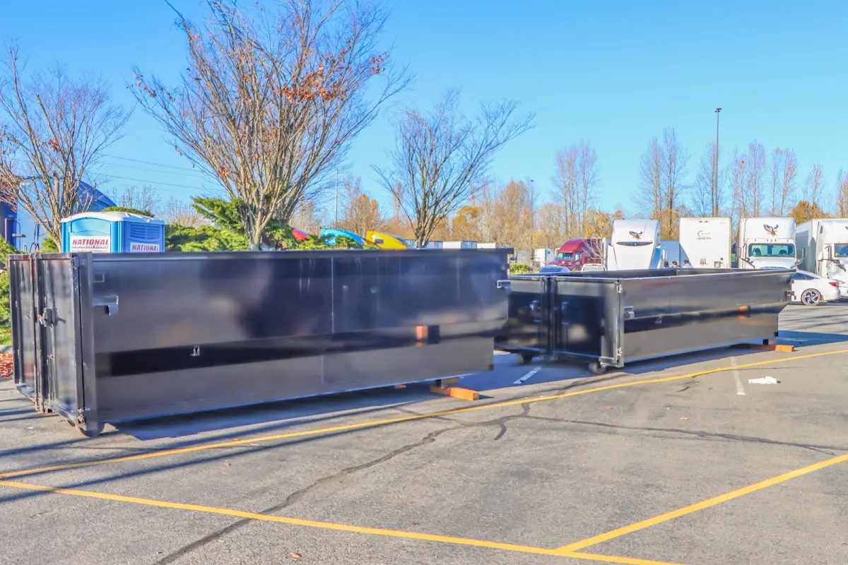 Professional dumpster rental service with roll-off container on residential driveway in Blendon